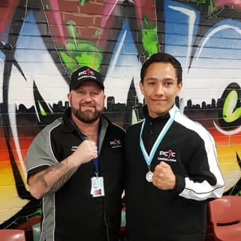 Boxing coaches poses for a photo