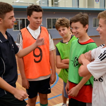 kids talking in a basketball court